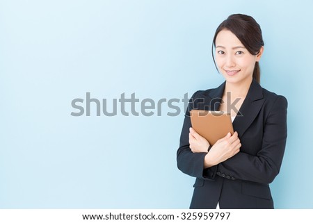portrait of asian businesswoman isolated on blue background