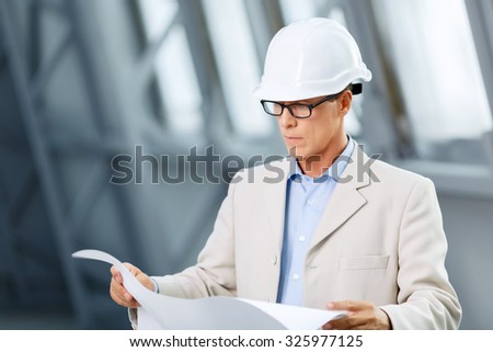 Involved in project. Professional serious concentrated srchitect holding plan and studying  while doing his job