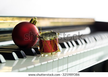 Christmas music illustrated with red Christmas ball on piano keyboard