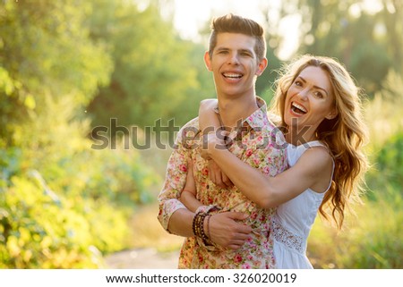 Love and happiness. Outdoor portrait of laughing loving couple embracing in park.