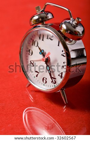 vintage alarm clock on red background
