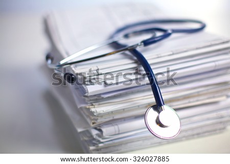 books folder file and stethoscope isolated on white background Royalty-Free Stock Photo #326027885