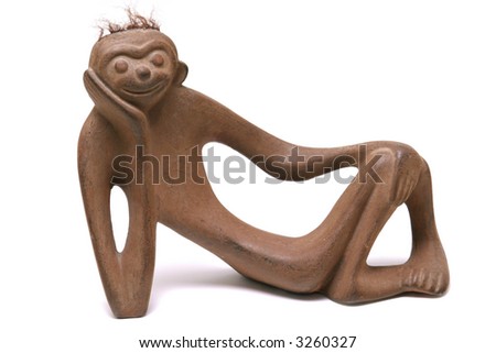 cute ceramic monkey smiling and relaxing isolated on white background