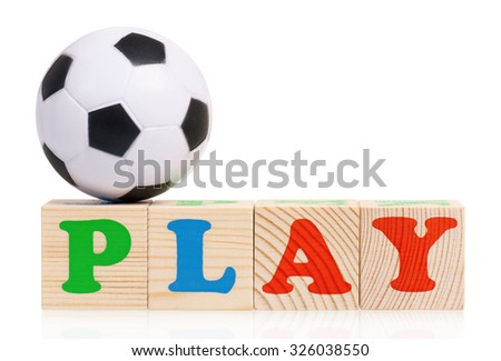 Wooden blocks arranged in the word PLAY and small soccer ball - isolated on white background