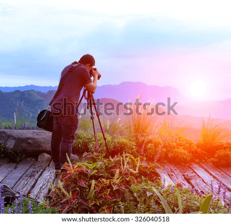 Nature photographer taking photos in the mountains