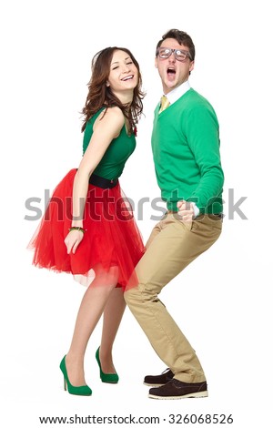 Interracial weird nerd couple dancing together. Excited caucasian young man wearing eyeglasses and smiling asian woman wearing 50 style clothes. Fifties nerd concept