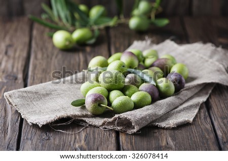 Raw olive for making oil on the wooden table, selective focus Royalty-Free Stock Photo #326078414