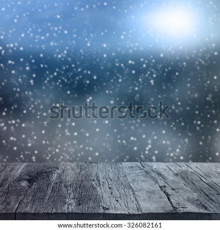 Wooden deck table over beautiful winter background