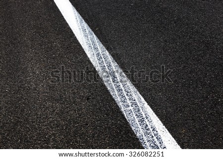   photographed close-up of road markings painted on the asphalt