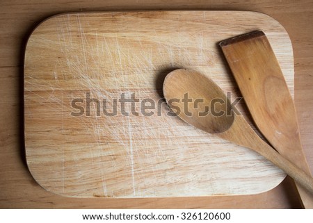 Wooden Board With Wooden Spoons On Wooden Background