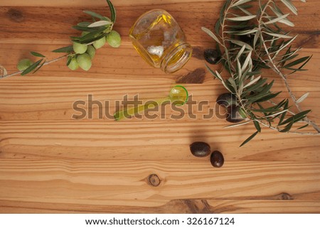 Olive branches on wood with Olive Oil