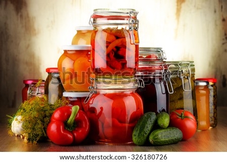 Jars with pickled vegetables and fruity compotes. Preserved food