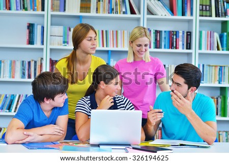Happy Group Of Young Students Studying Together In Library