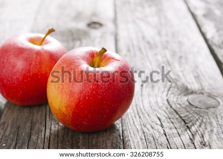 two apples on old wood table