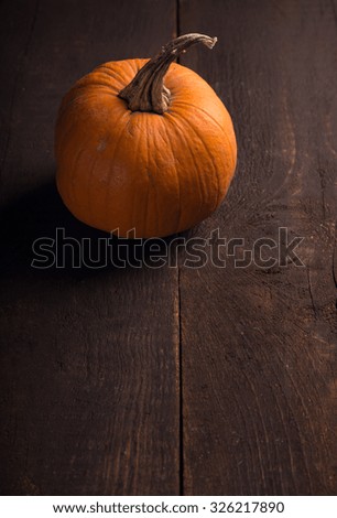 one single pumpkin over wooden background