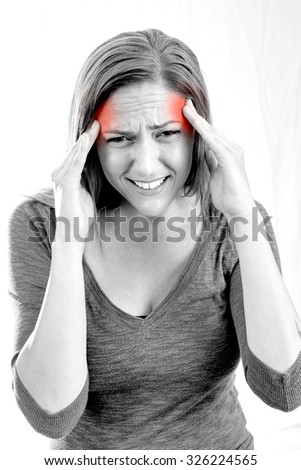 Woman holding her head in pain with headache - black and white 
