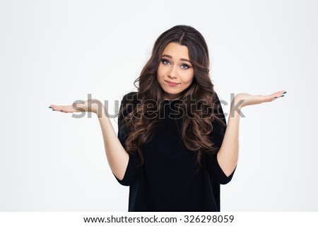 Portrait of a pretty woman shrugging shoulders isolated on a white background Royalty-Free Stock Photo #326298059