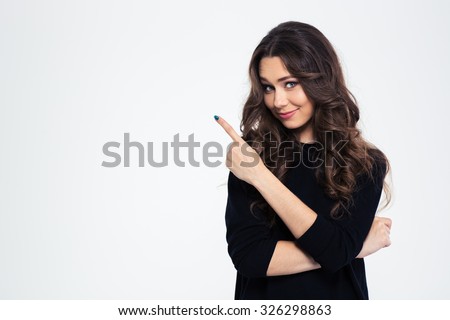 Portrait of a pretty girl pointing finger away isolated on a white background