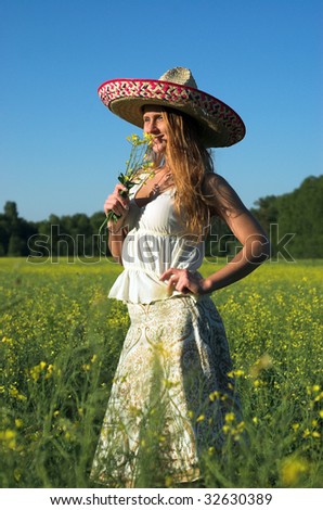 Young attractive woman standing in a field