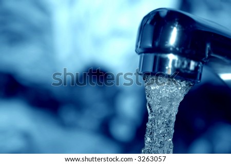 Macro of water flowing from a tap - shallow DOF