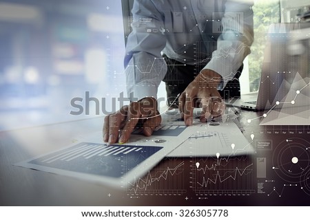 close up of businessman hand working on laptop computer with financial business graph information diagram on wooden desk as concept Royalty-Free Stock Photo #326305778