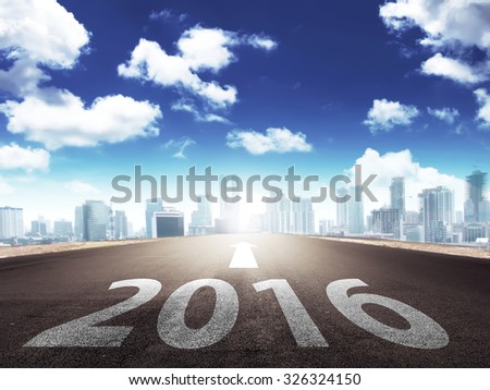 Year 2016 on the street with arrow toward to the city