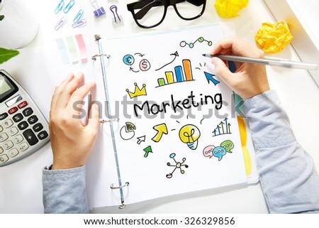  Person drawing Marketing concept on white paper in the office