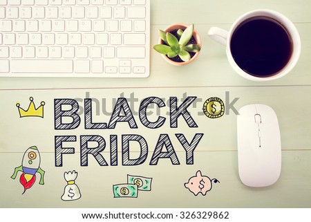 Black Friday message with workstation on a light green wooden desk