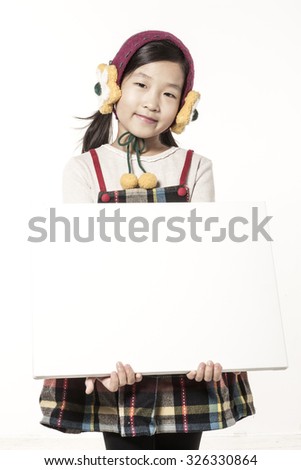 A asian(japan, chinese, korea) pretty girl hold a white(blink, empty) canvas frame with a smile isolated white at the studio.