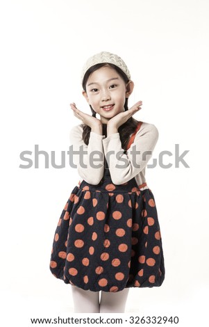 A asian(japanese, chinese, korean) pretty girl(kid, children) portrait with smile in the winter, christmas isolated white at the studio.