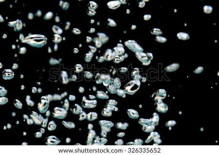 Movement of the air bubbles on a black background.