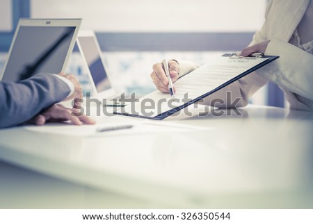 Business man signing a contract Royalty-Free Stock Photo #326350544