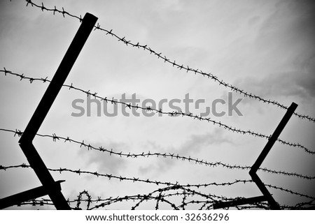 photo of old rusty barbed wire against sky