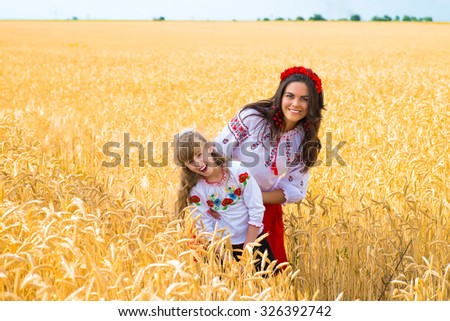 Mom and daughter in wheat field