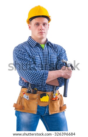 young worker holding hammer with other tools.