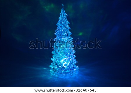 Christmas tree toy shining with a beautiful shadow Northern Lights background