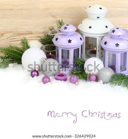 Violet and white candlesticks and Christmas balls on snow on a white background. 
Christmas background with a place for the text.