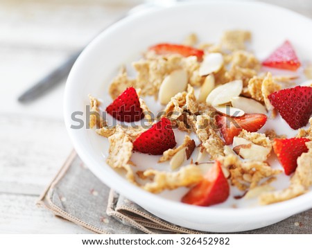 bowl of cereal with strawberries and almonds Royalty-Free Stock Photo #326452982