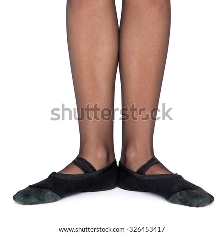The initial position of the feet in the dance. The first position. Female feet in gym shoes on a white background.