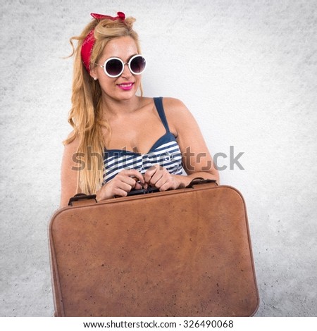 Pin-up woman holding a suitcase