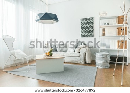 Trendy furniture in small cozy living room Royalty-Free Stock Photo #326497892