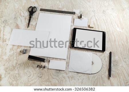 Blank stationery and corporate identity set on light wooden background. Mock-up for graphic designers portfolios. Top view.