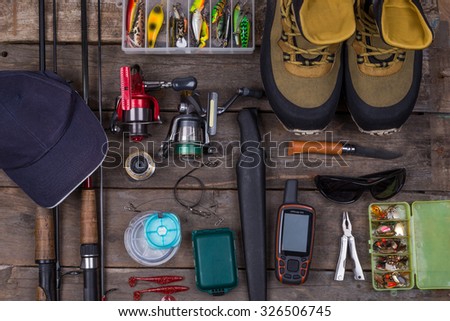 fishing tackles and fishing gear on tinber boards look on top Royalty-Free Stock Photo #326506745