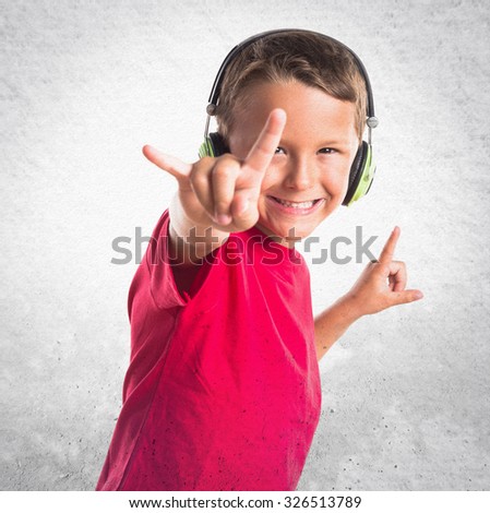 Kid listening music making horn gesture 