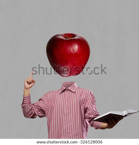 Businessman with book in hand and apple instead of head