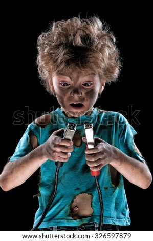Boy has a electric shock on dark background