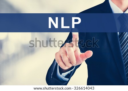 Businessman hand touching NLP (or Neuro Linguistic Programming) sign virtual screen