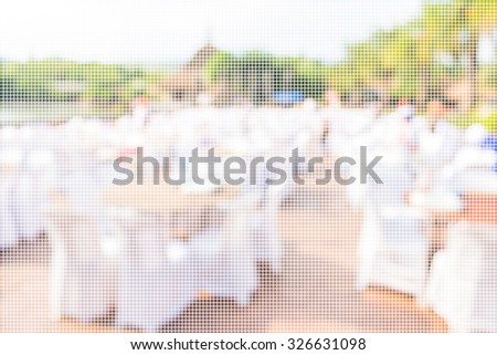 blur image of Tables and decoration prepared for an outdoor party for background usage.(dot Pattern Pixelation effect image)