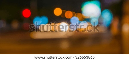 image of blur street and billboard with warm colorful lights in night time for background usage .