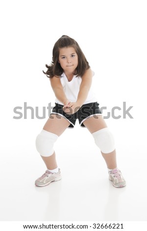 Cute Caucasian girl hitting the ball in volleyball isolated on a white background